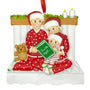 Family of 3 Christmas ornament with mom and dad reading a book to child