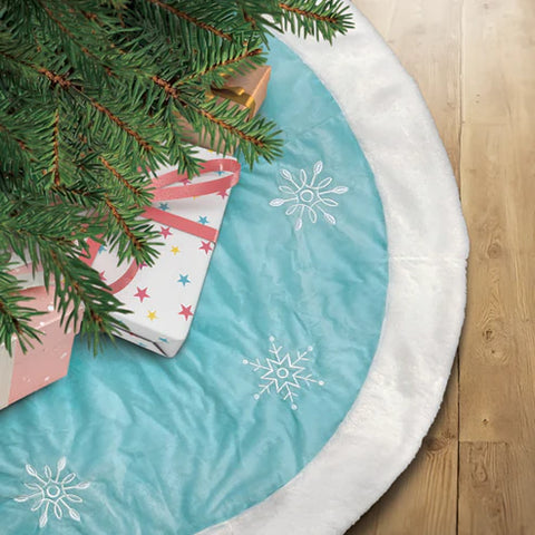 48" pastel blue snowflake treeskirt from Old World Christmas shown under a Christmas tree with wrapped presents.