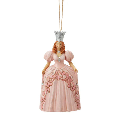 Licensed Wizard of Oz Jim Shore Glinda ornament in a flowing pink gown with silver crown and jeweled accents, front view.