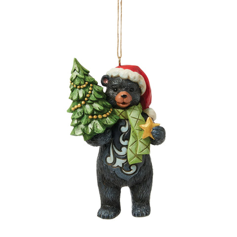 Front view of Jim Shore Lodge Black Bear Ornament featuring a black bear with green scarf, Santa hat, Christmas tree, and gold star.