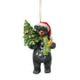 Front view of Jim Shore Lodge Black Bear Ornament featuring a black bear with green scarf, Santa hat, Christmas tree, and gold star.