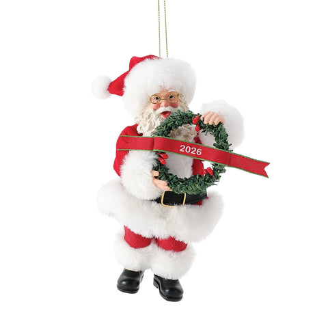 Front view of 2026 Dated Possible Dreams Clothtique Santa Ornament featuring Santa in a faux fur trimmed suit holding a wreath with 2026 ribbon.