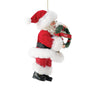 Side view of 2026 Dated Possible Dreams Clothtique Santa Ornament holding a holiday wreath with red 2026 ribbon and faux fur details.