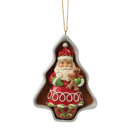 Jim Shore Cookie Cutter Santa Ornament featuring Santa inside a tree-shaped cookie cutter holding a gingerbread cookie, front view.