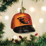 Glass ornament shaped like a baseball cap with a Oregon State logo, hanging on a Christmas tree.