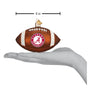 Decorative football ornament with Alabama Crimson Tide logo held in a hand for scale.