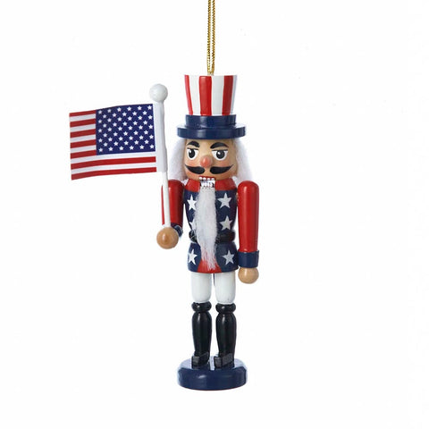American Flag Nutcracker Ornament with red, white, and blue uniform, star-spangled jacket, striped top hat, American flag, white beard, and gold hanging cord.