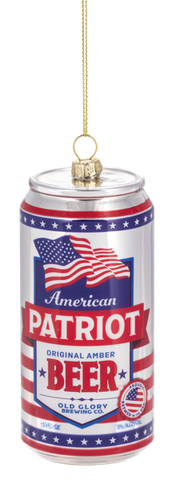 Glass ornament shaped like a red, white, and blue beer can labeled “American Patriot Beer,” featuring waving American flags and patriotic stars and stripes details.