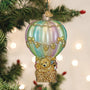 Decorative ornament of a teddy bear in a hot air balloon on a Christmas tree.
