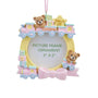 Baby’s first Christmas girl train picture frame ornament with pink bow, teddy bears, pastel blocks, and 2" x 2" photo opening.