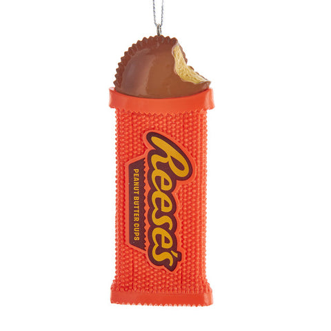 Ornament shaped like a bright orange Reese’s Peanut Butter Cups wrapper with a bitten peanut butter cup showing at the top.
