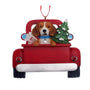 Decorative Christmas Beagle ornament with a dog in a red truck carrying a tree and gift.