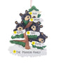 Personalized bear family of 4 ornament with four black bears in a snow-covered evergreen tree and space for four names, a short phrase, and year. Shown with personalization example. 