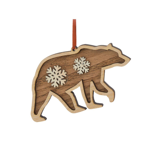 Layered wood bear silhouette ornament with white snowflake accents, natural wood trim, and a red ribbon hanger.