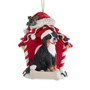 Bernese Mountain Dog wearing a Santa hat in a red dog house Christmas ornament with colorful lights and bone-shaped plaque.