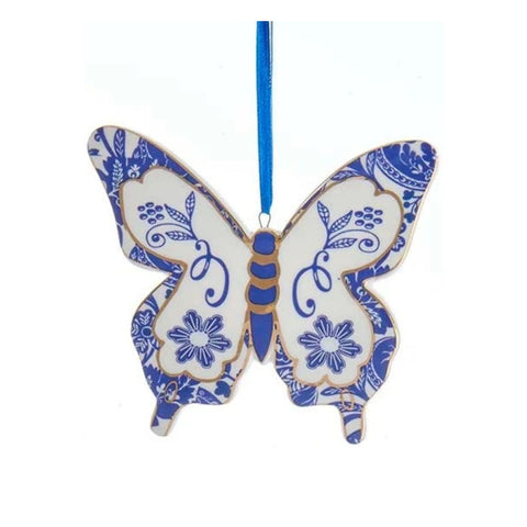 Blue and white butterfly ornament in a Delft-inspired style with blossom motifs, floral details, and a blue hanging ribbon.