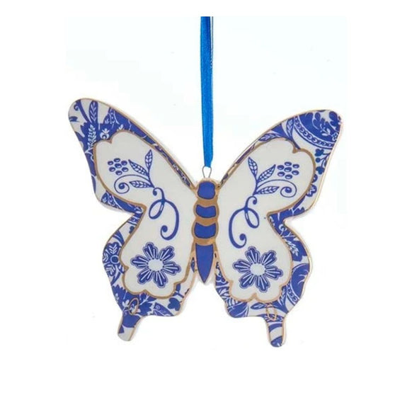 Blue and white butterfly ornament in a Delft-inspired style with blossom motifs, floral details, and a blue hanging ribbon.