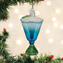 Blue cocktail glass ornament on a Christmas tree with lights in the background