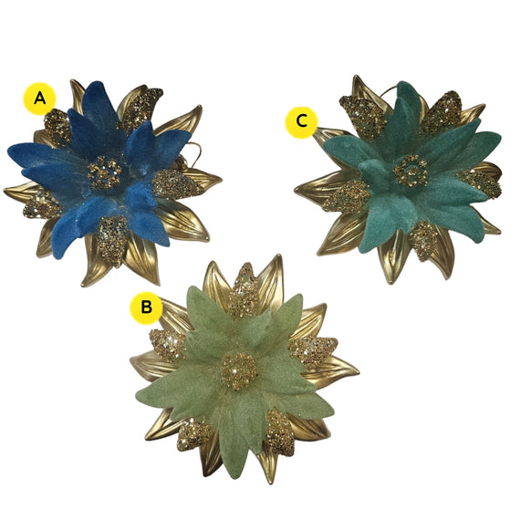 Blue poinsettia ornament with soft petals, gold leaves, and glitter accents.

Green and teal poinsettia ornaments with metallic gold leaves and glittered details.