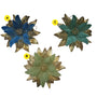 Blue poinsettia ornament with soft petals, gold leaves, and glitter accents.

Green and teal poinsettia ornaments with metallic gold leaves and glittered details.