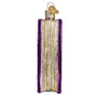 Decorative ornament shaped like a 'Book of Spells' with purple cover and gold accents on a white background. Side View