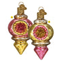 Two ornate glass Christmas ornaments with pink and gold designs on a white background.