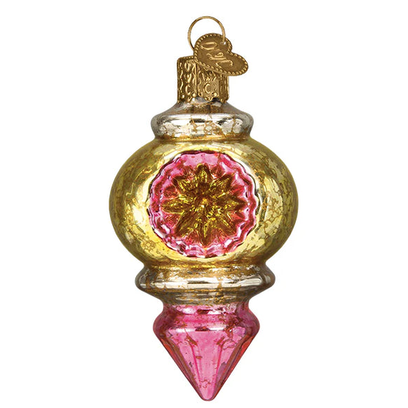 Decorative glass ornament with gold and pink design on a white background