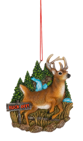 Buck Off Deer ornament featuring a standing brown buck with antlers in a woodland scene, complete with evergreen trees, a blue waterfall, tall grass, and a rustic “Buck Off!” sign.