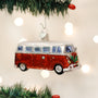 Red Camper van ornament on a Christmas tree with blurred lights in the background