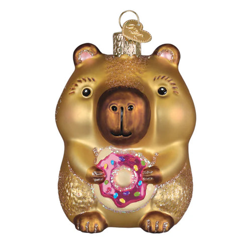 Capybara ornament holding a pink donut with sprinkles on a white background