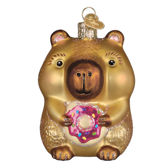 Capybara ornament holding a pink donut with sprinkles on a white background