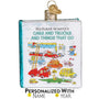 Decorative ornament shaped like a book titled 'Richard Scarry's Cars and Trucks and Things That Go' with colorful illustrations on a white background.