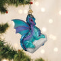 Decorative dragon ornament on a Christmas tree with lights in the background