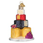 Decorative ornament resembling a cheese tower with fruits on a white background