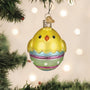 Decorative chick ornament on a Christmas tree with lights in the background