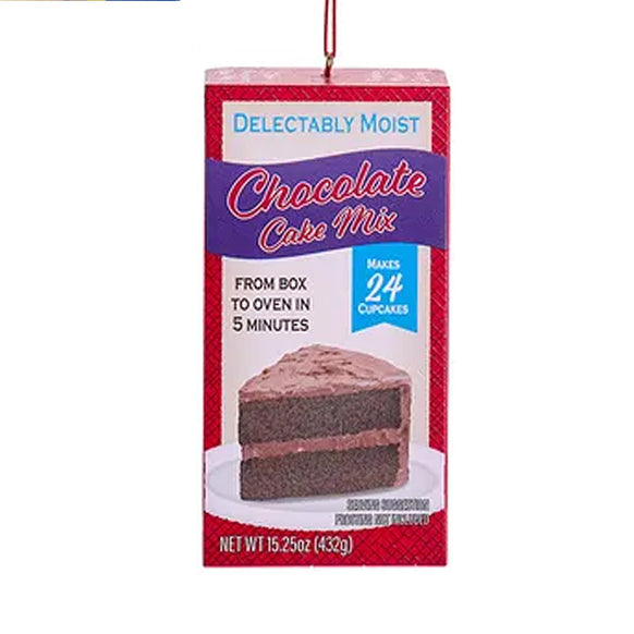 Christmas Ornament that looks like boxed cake mix with a slice of chocolate cake on the front 