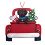 Christmas ornament of a Chocolate Lab in a red truck with a tree and gift, personalized with a name and year