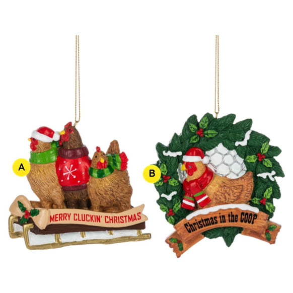Two chicken Christmas ornaments shown side by side, including hens on a sled with “Merry Cluckin’ Christmas” and a hen in a wreath nest with “Christmas in the Coop.”