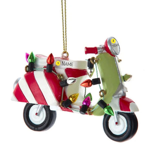 Personalized scooter ornament with red and white candy cane stripes, a green front panel, and colorful Christmas lights wrapped around it.