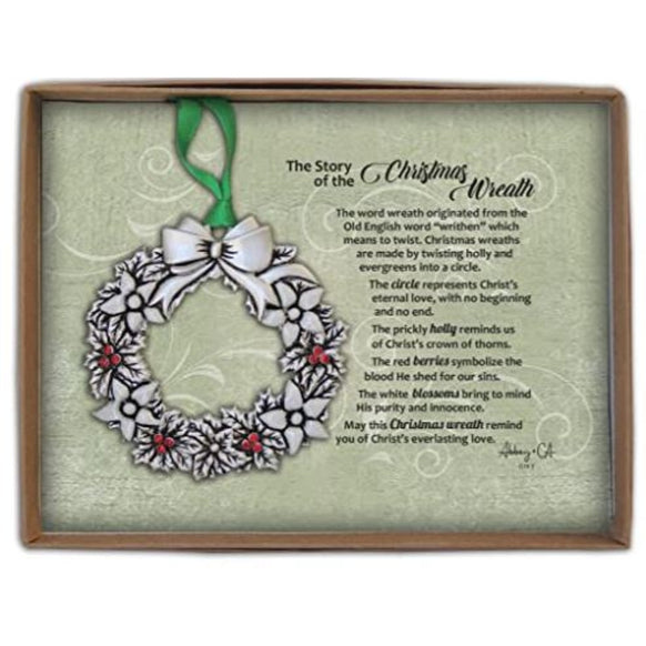 Story of Christmas Wreath Ornament in gift box with silver wreath, holly leaves, white blossoms, red berries, green ribbon, and printed story card.
