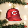 Red baseball cap shaped ornament with a white logo on a Christmas tree.