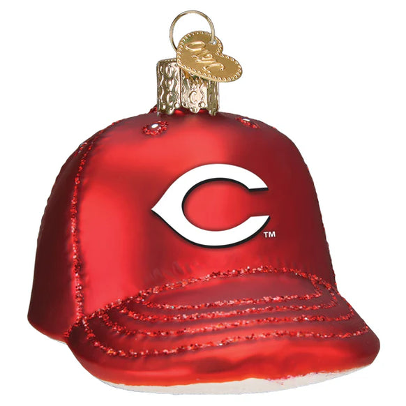 Red glass ornament shaped like a baseball cap with a white 'C' logo on a white background