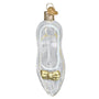 Clear glass Christmas ornament shaped like Cinderella's Slipper with a gold bow on a white background