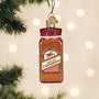 Decorative ornament shaped like a jar of ground cinnamon on a Christmas tree.