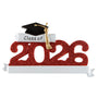 Graduation-themed ornament with 'Class of 2026' text, red glittery number design, and black cap with gold tassel on a white background.