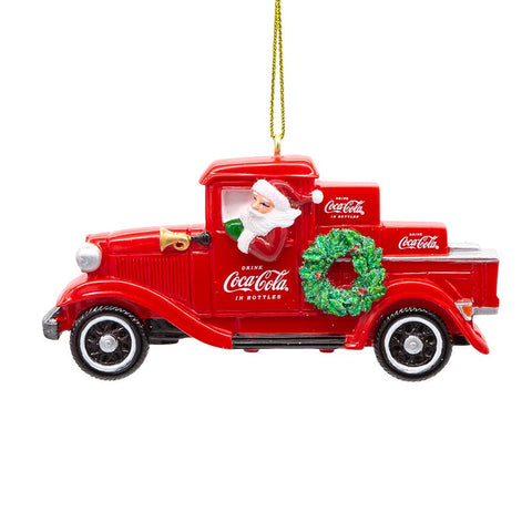 Red Coca-Cola delivery truck ornament with Santa driving, Coca-Cola crates in the back, and a glittered green wreath on the door.
