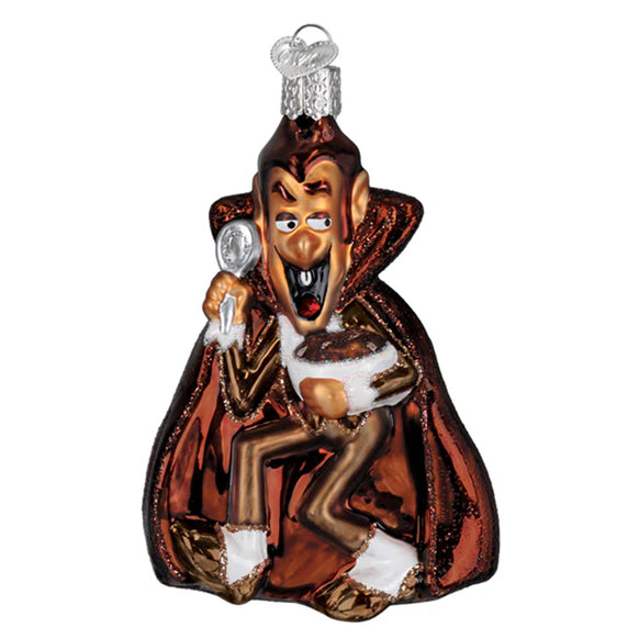 Glass ornament of a Count Chocula with a cape and staff on a white background