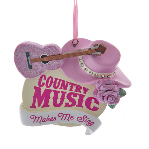 Western ornament with a pink glittered guitar, pink cowboy hat, rose accent, and the phrase Country Music Makes Me Sing.