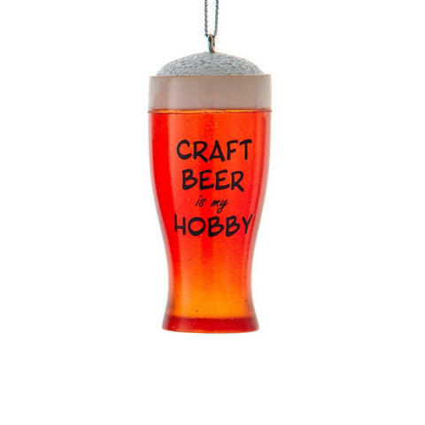 Ornament shaped like a frothy pint glass filled with amber beer and the words “Craft Beer is my Hobby.”
