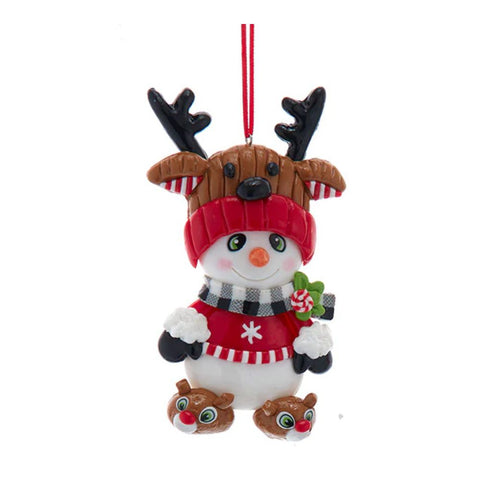 Claydough snowman ornament wearing a red sweater, black-and-white scarf, reindeer hat, and tiny reindeer slippers.